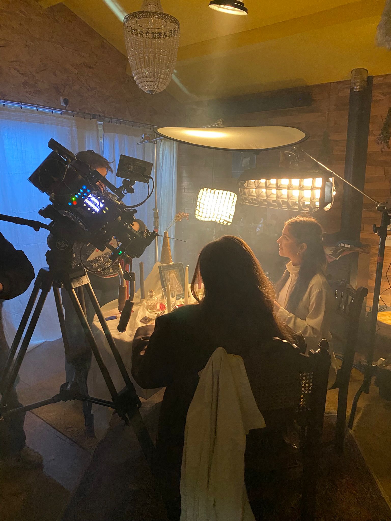 Woman in white dress and gold earrings walking down runway